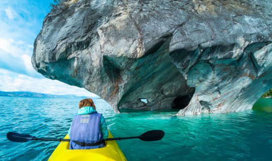 woman kayaking up to the marble caves chile
