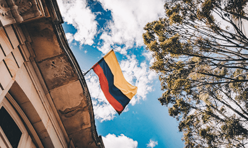 Upward view of sky with Colombian flag