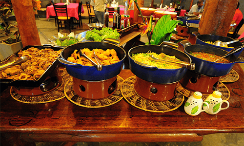 A table with five different Brazilian dishes