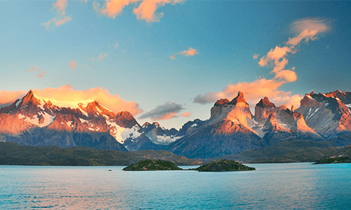 A gorgeous mountain range above a body of water in Torres del Paine