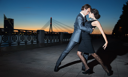 A couple dances the tango, while the sun sets in Buenos Aires