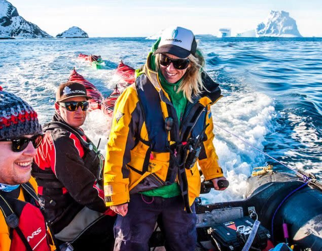 Antarctica travelers sit on motorized raft