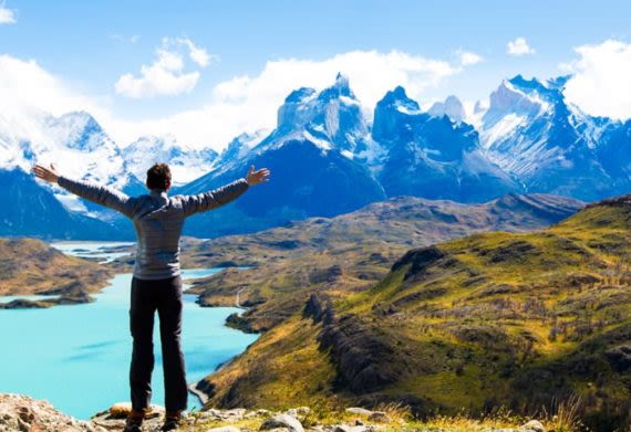 Hiker stands against Torres del Paine mountains