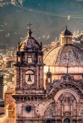 Large cathedral building and view over city center in valley of Cusco on a Cusco Tours