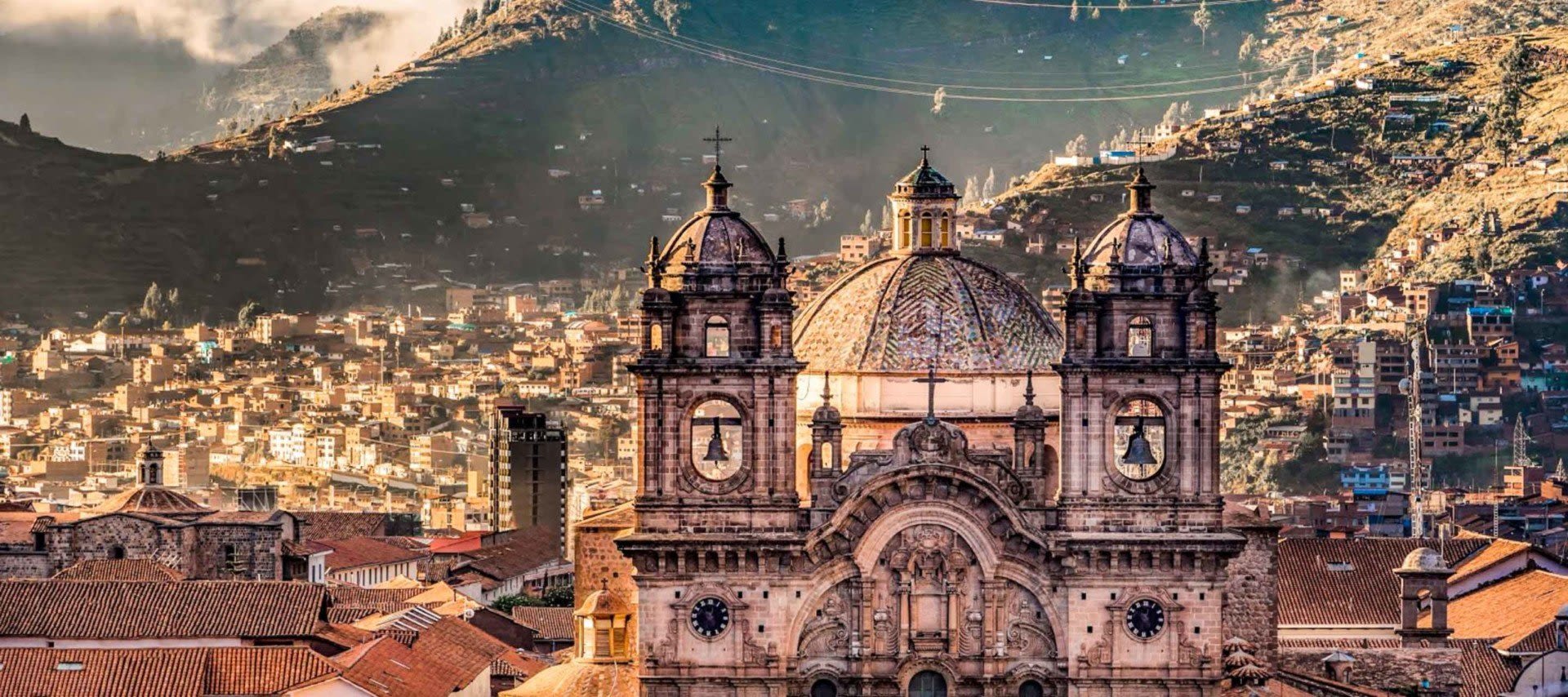 Large cathedral building and view over city center in valley of Cusco on a Cusco Tours