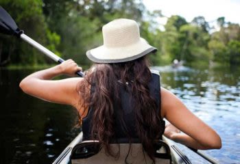 woman kayaking in peru amazon river