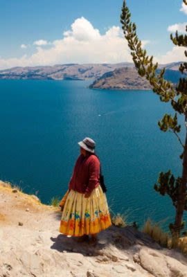 Two women stand near Lake Titicaca