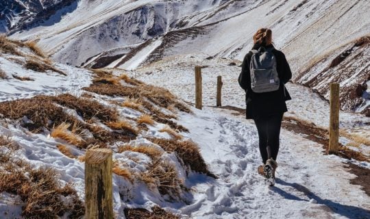 woman-starting-snow-covered-hiking-trail