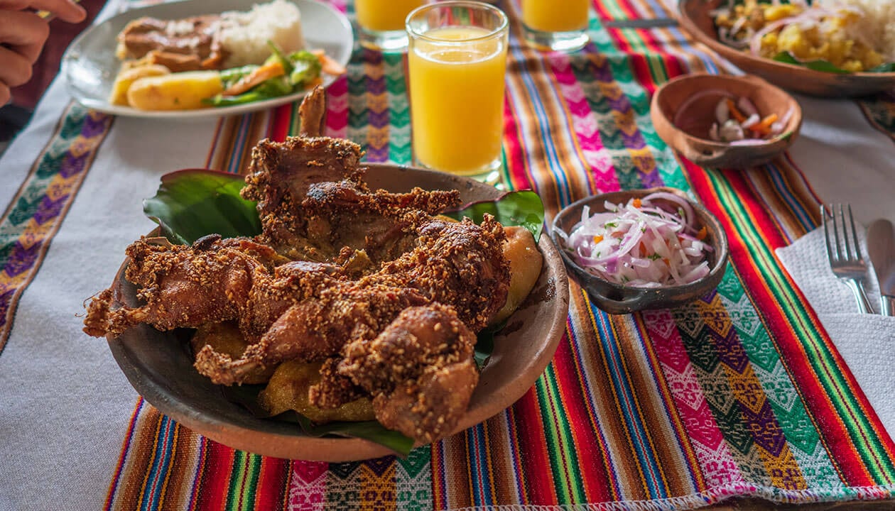 fried cuy or guinea pig on peruvian table cloth