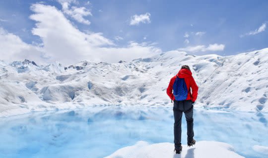 man exploring glacier