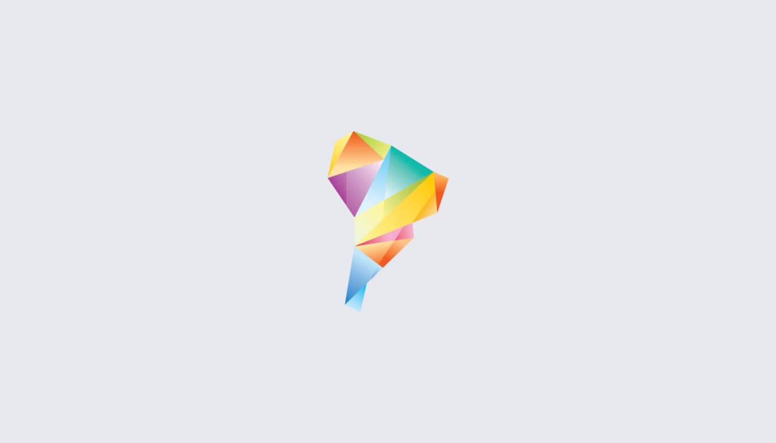 A geometric, multicolored abstract shape with sharp angles—reminiscent of the vibrant landscapes and things to see in Patagonia—features hues of yellow, orange, blue, purple, and green, centered on a light gray background.
