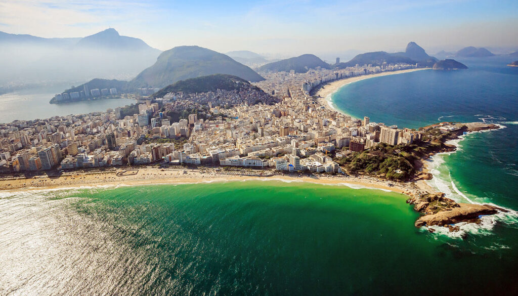 Aerial view of Rio de Janeiro, Brazil, showcasing the city’s coastline with sandy shores, turquoise water, and lush mountains under a clear sky—one of the best beaches in Brazil.