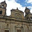 A view of a historic stone cathedral with two bell towers, arched windows, and detailed carvings, set against a partly cloudy blue sky—a true landmark where architectural beauty meets top shelf service.