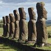 Six large stone Moai statues stand in a row on grassy land under a cloudy sky on Easter Island, a must-see stop to organise into your travel itinerary.