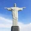 The Christ the Redeemer statue in Rio de Janeiro, Brazil, stands with outstretched arms against a clear blue sky—an iconic sight that makes any visit here the trip of a lifetime.