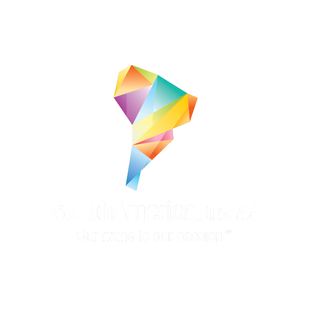 A colorful, geometric illustration of the South American continent above the text SouthAmerica.travel and the slogan Our name is our passion™ on a light gray background, highlighting transparent booking conditions.