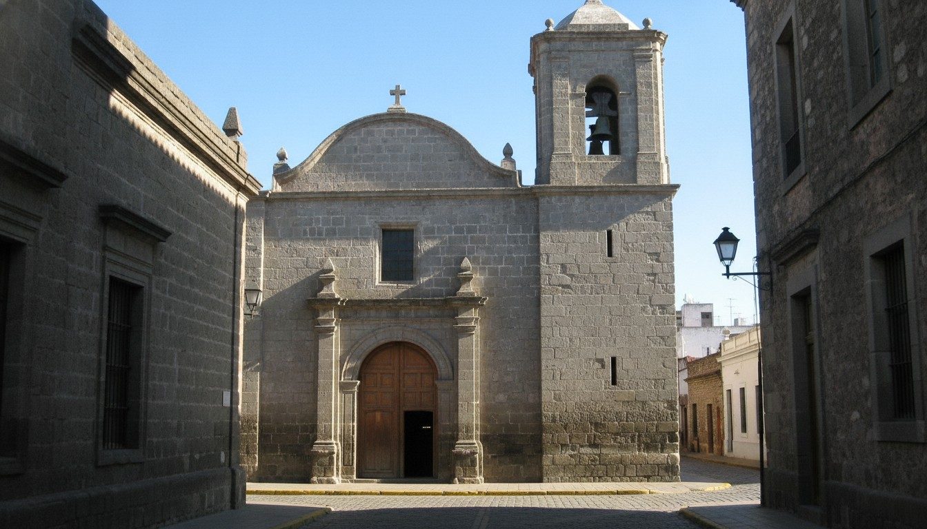 The Baroque stone facade and bell tower of the Jesuit church on the Manzana Jesuítica in central Córdoba, Argentina