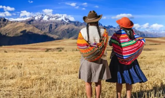 two-indigenous-women-looking-out-at-sacred-valley
