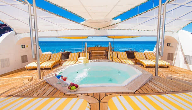 the sundeck and jacuzzi of a galapagos cruise