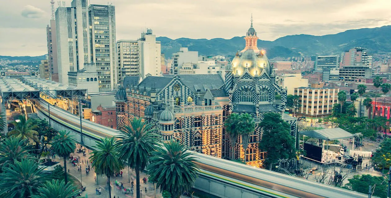 Medellin downtown cathedral and city light rail.