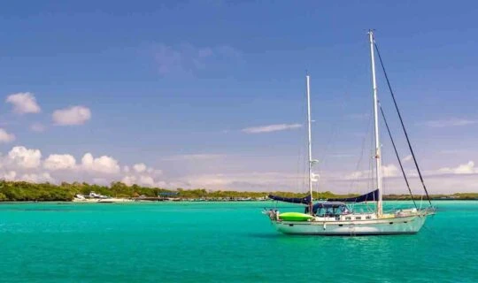 Isabela-Island-with-sail-boat-anchored-off-bay