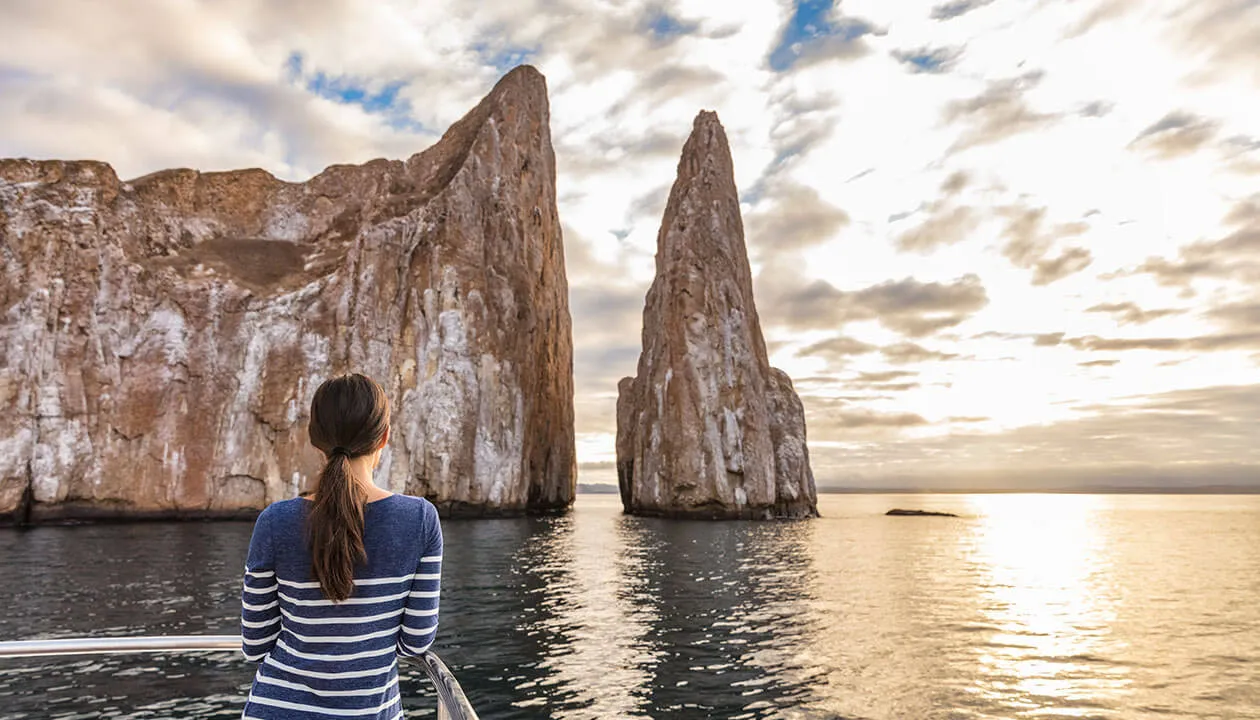 woman staring at kicker rock islet