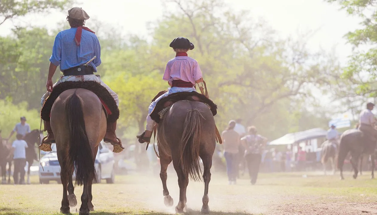 child and man riding horseback in argentina