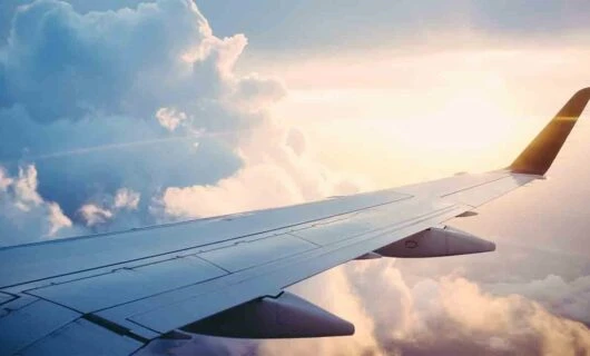 plane-wing-in-air-with-sunrise