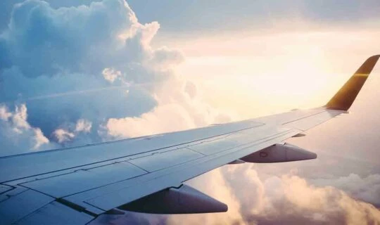 plane-wing-in-air-with-sunrise