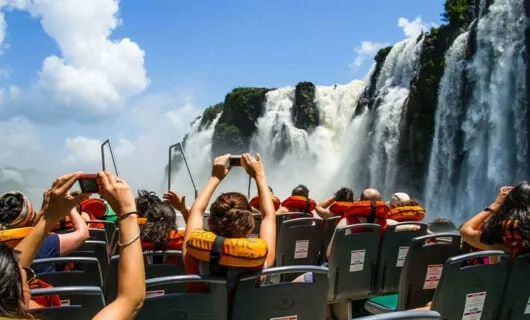 tourists in boat at iguazu