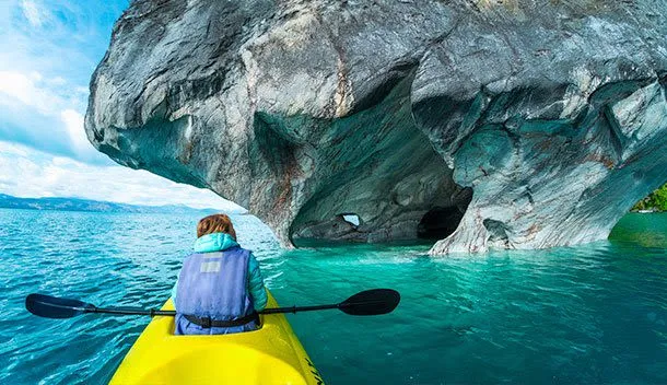 girl kayaking underneath the marble caves