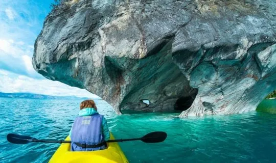 woman kayaking up to the marble caves chile