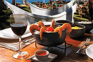 A Moqueca food dish on a sunny table