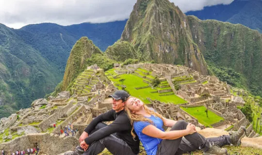 Couple sitting on Machu Picchu Mountain