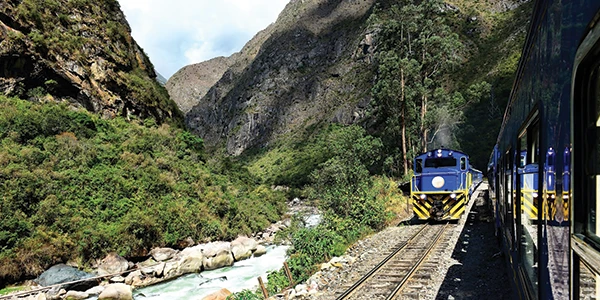 Two trains passing each other in the mountains 