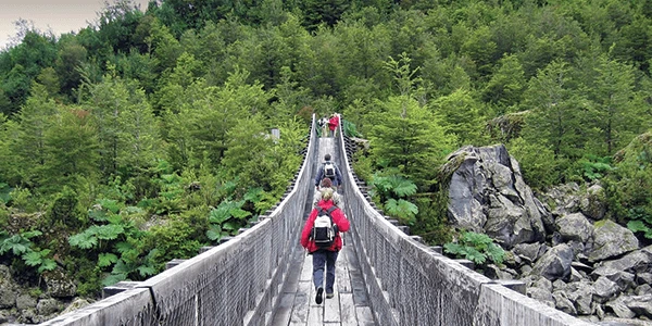 Crossing a bridge while on a hike in Patagonia