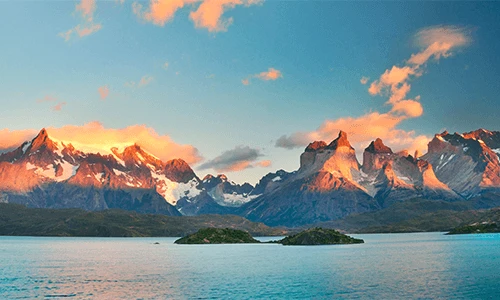 A gorgeous mountain range above a body of water in Torres del Paine