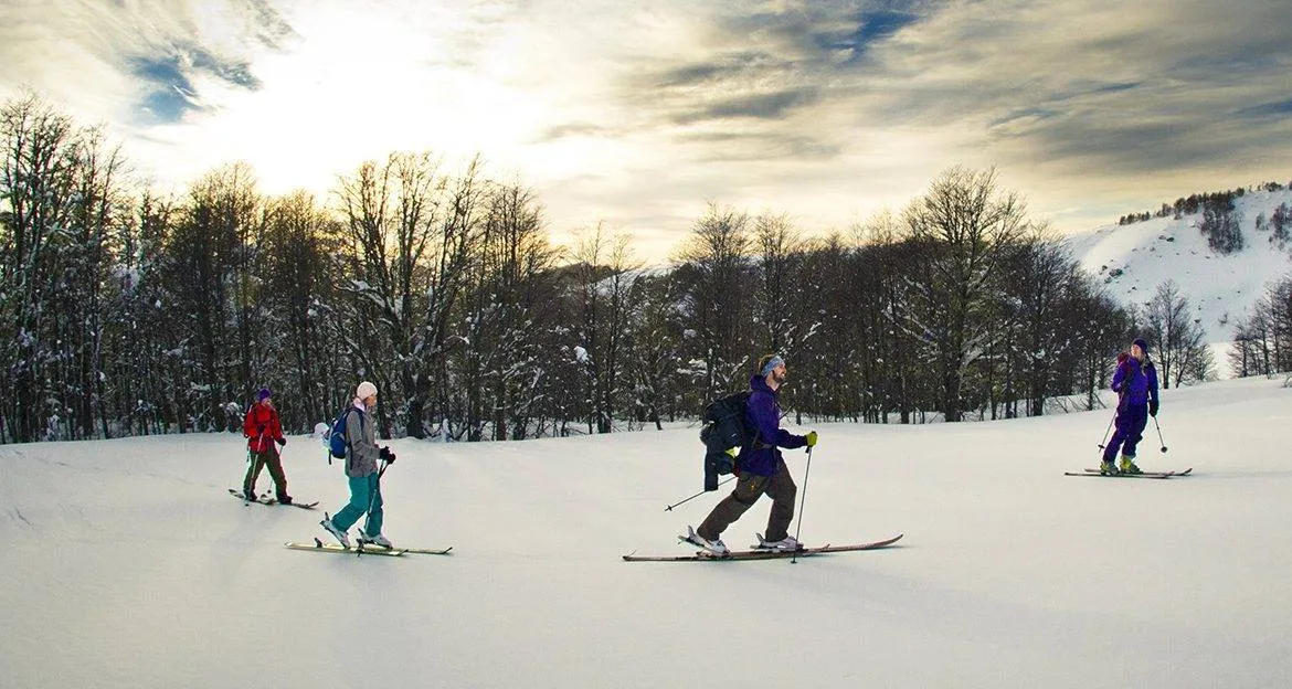 group-having-fun-skiing-on-mountain-slope
