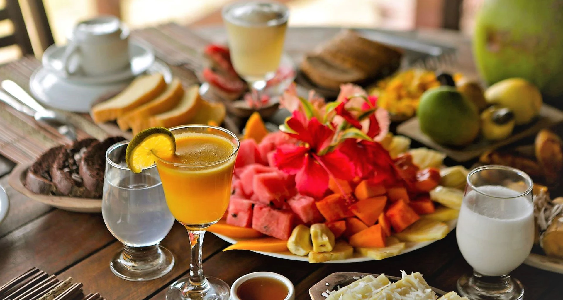 Decadent meal prepared on table with fruit and drinks