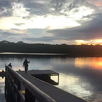 Man enjoying sunset at Napo center waterfront