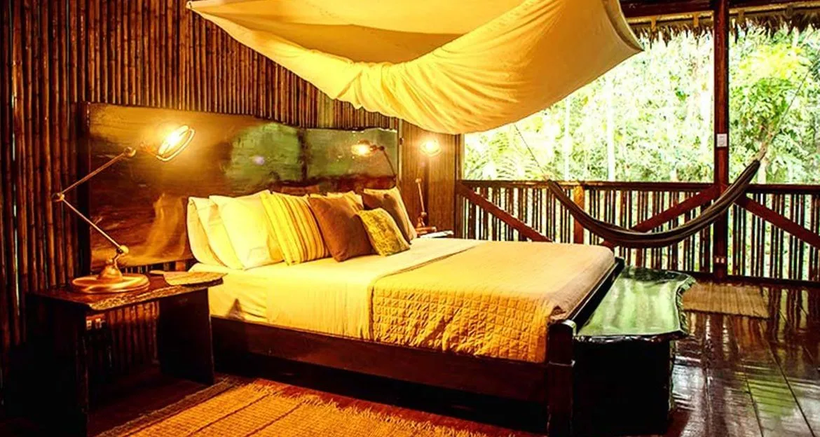 inside-the-refugiosamazonas-bedroom-with-canopy-bed-and-view-of-jungle