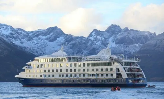 Stella Australis Cruise in ice waters with mountain background