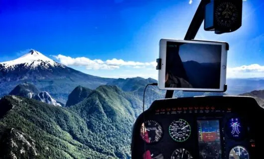 View of mountains past instrument panel of mountains
