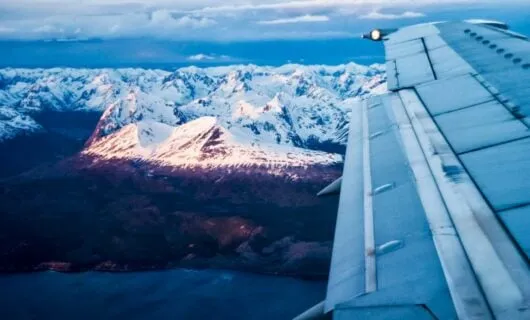 Airplane wing over Andes mountains near Ushaia, Argentina