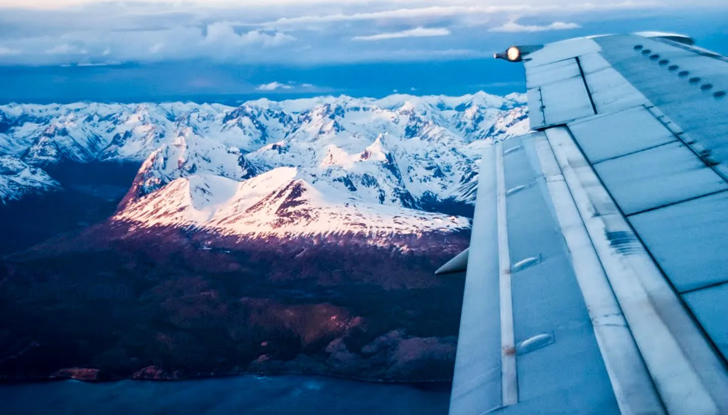 Airplane wing over Andes mountains near Ushaia, Argentina
