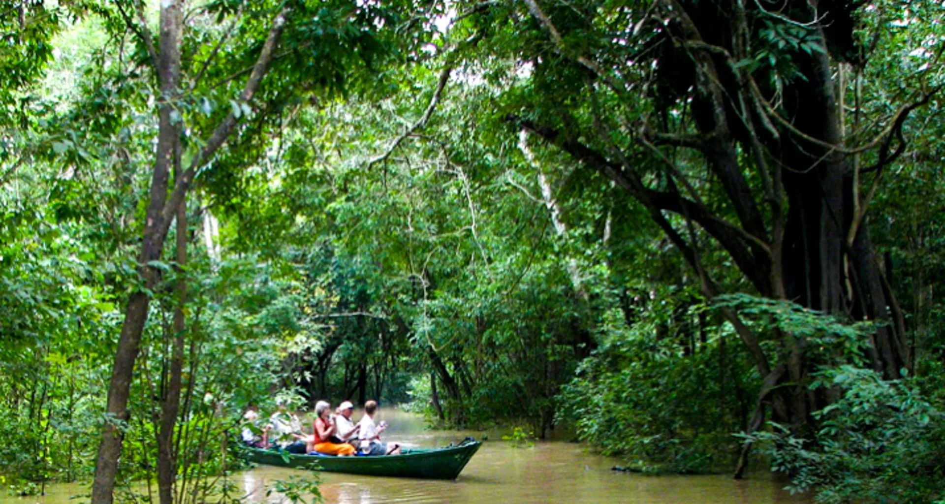 Group of travelers canoe through Amazon
