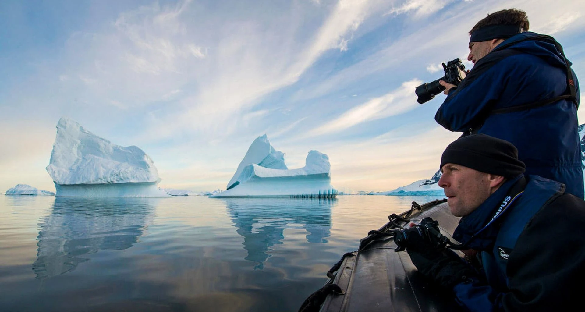 Travelers use camera while on an Antarctica boat