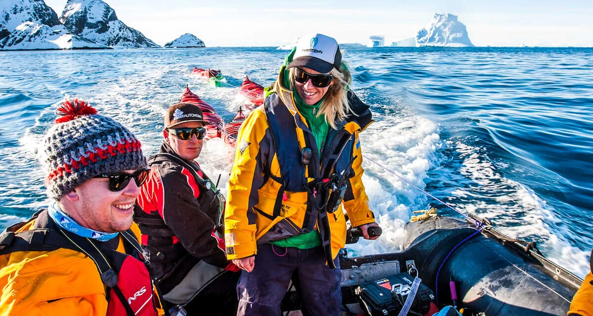 Antarctica travelers sit on motorized raft