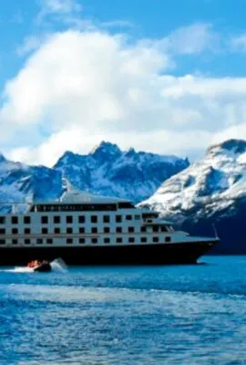 Argentina Cruise ship in front of mountains in Patagonia