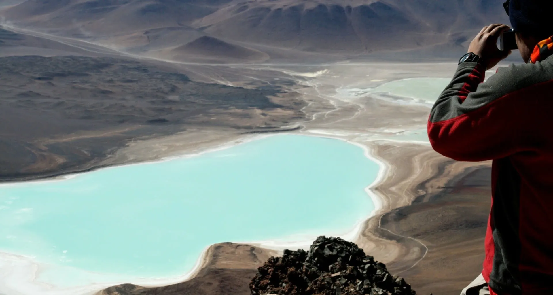 Traveler takes picture of valley lake